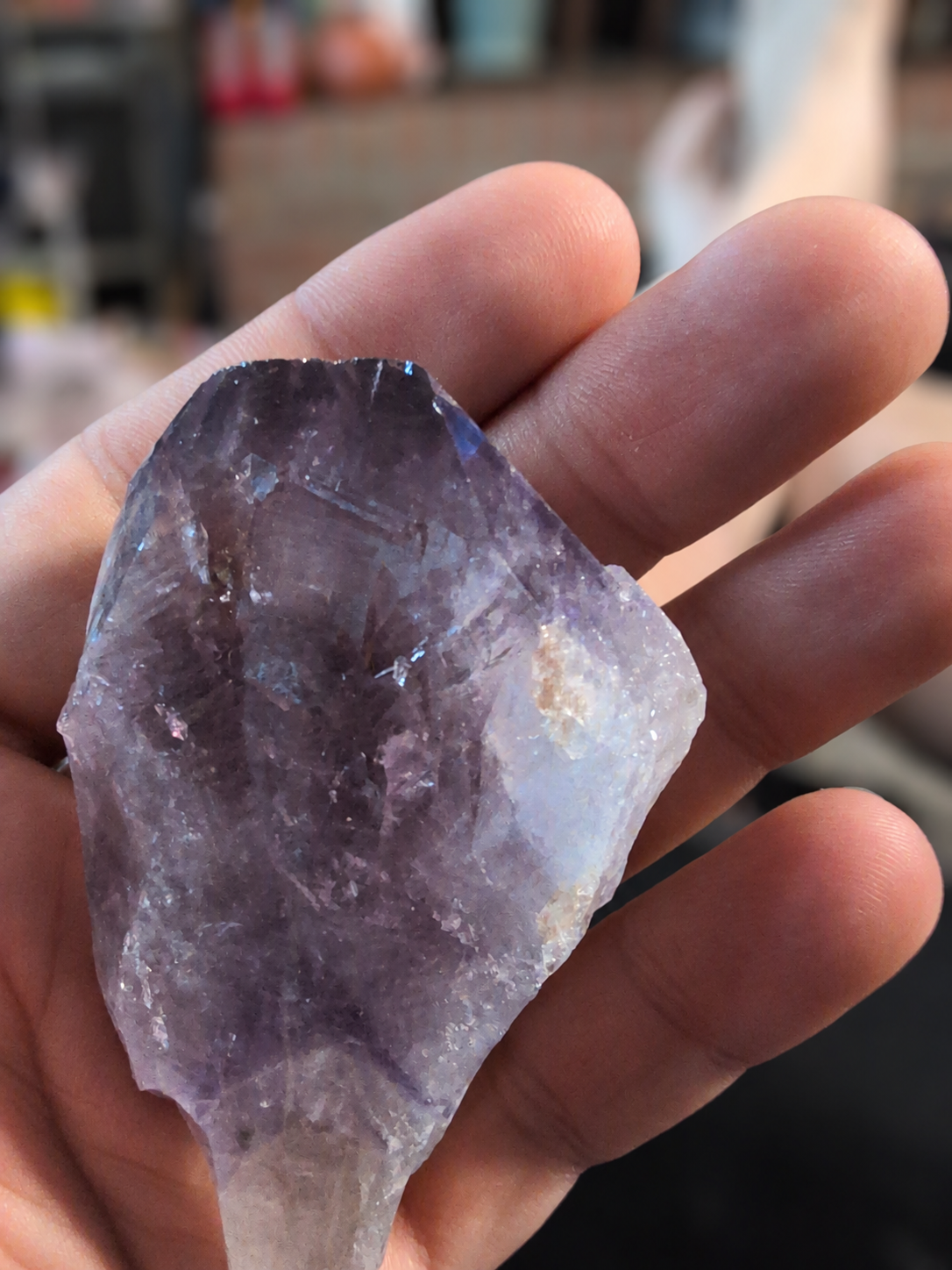 Natural amethyst point held in a hand