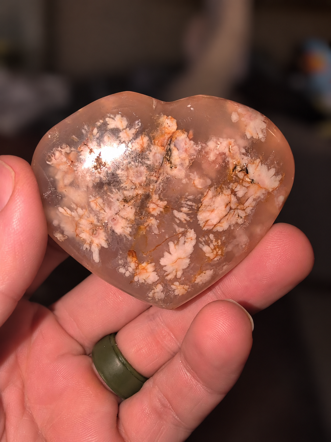 Flower agate heart held in a hand