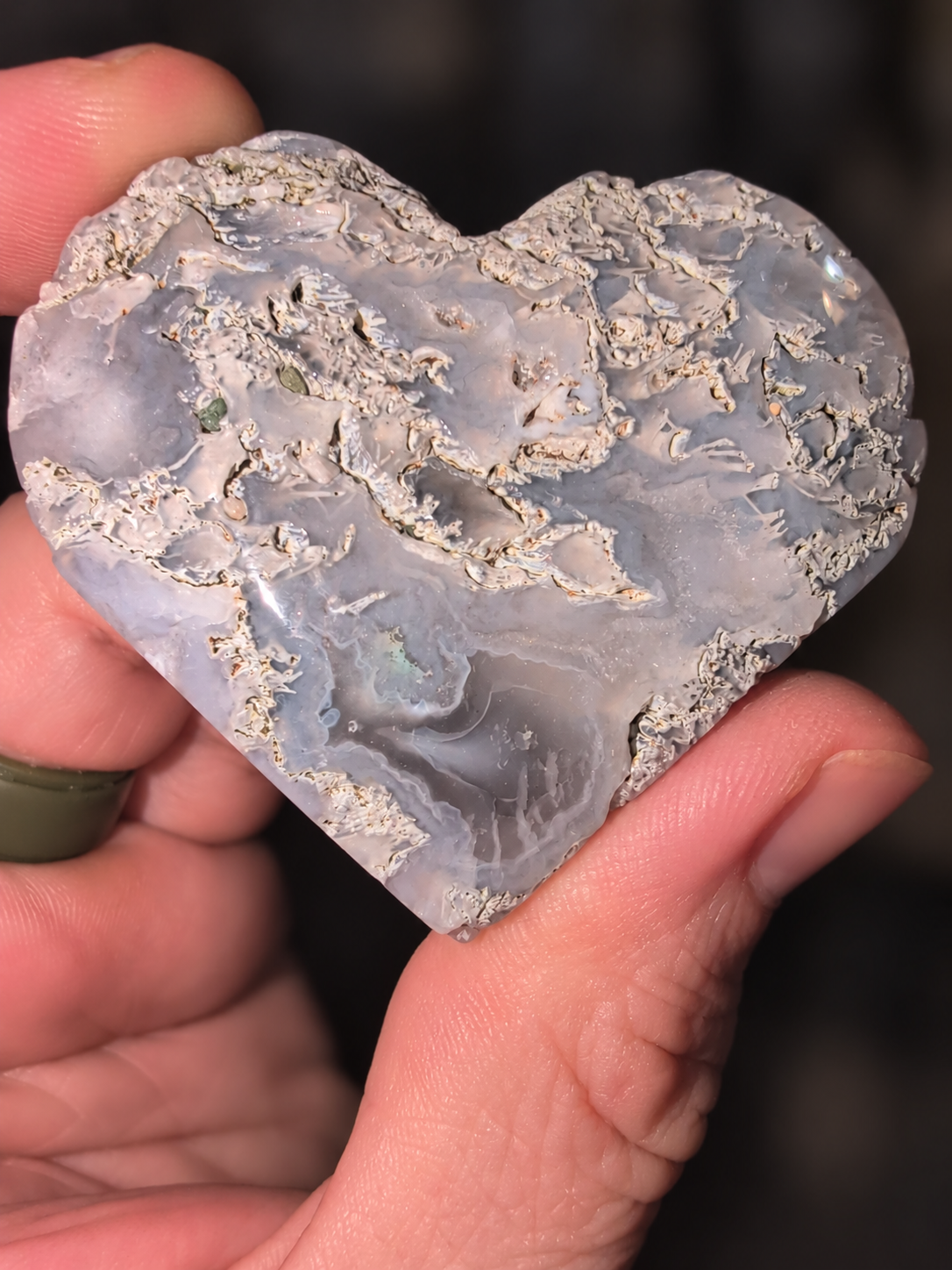 Gray agate heart held in a hand
